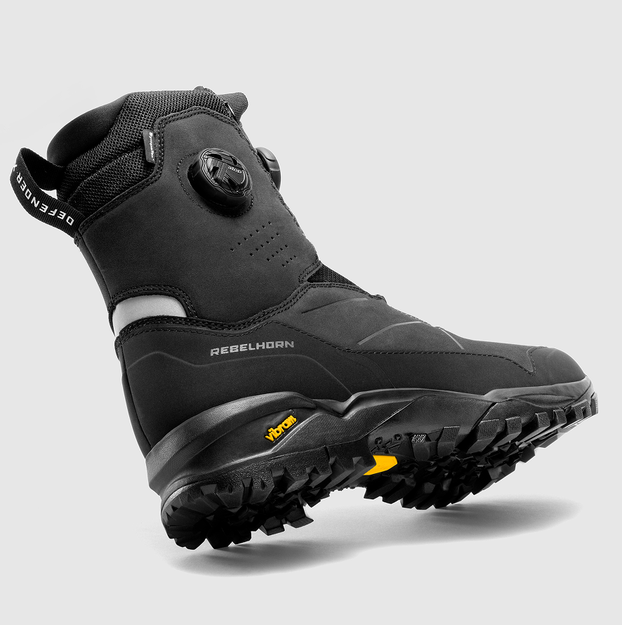 Black hiking boot with visible brand logos on a gray background